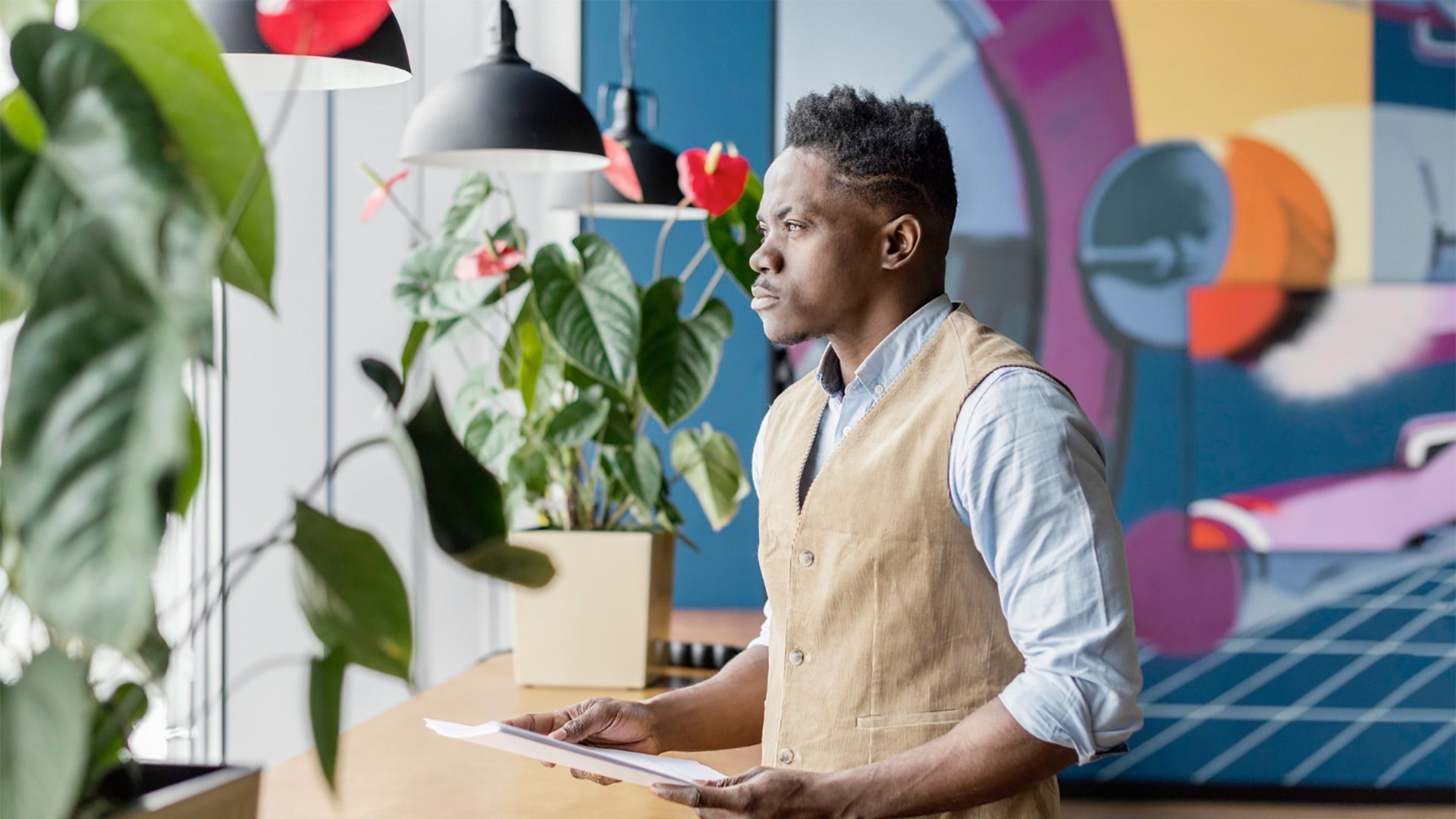 side-view-man-holding-papers-workplace